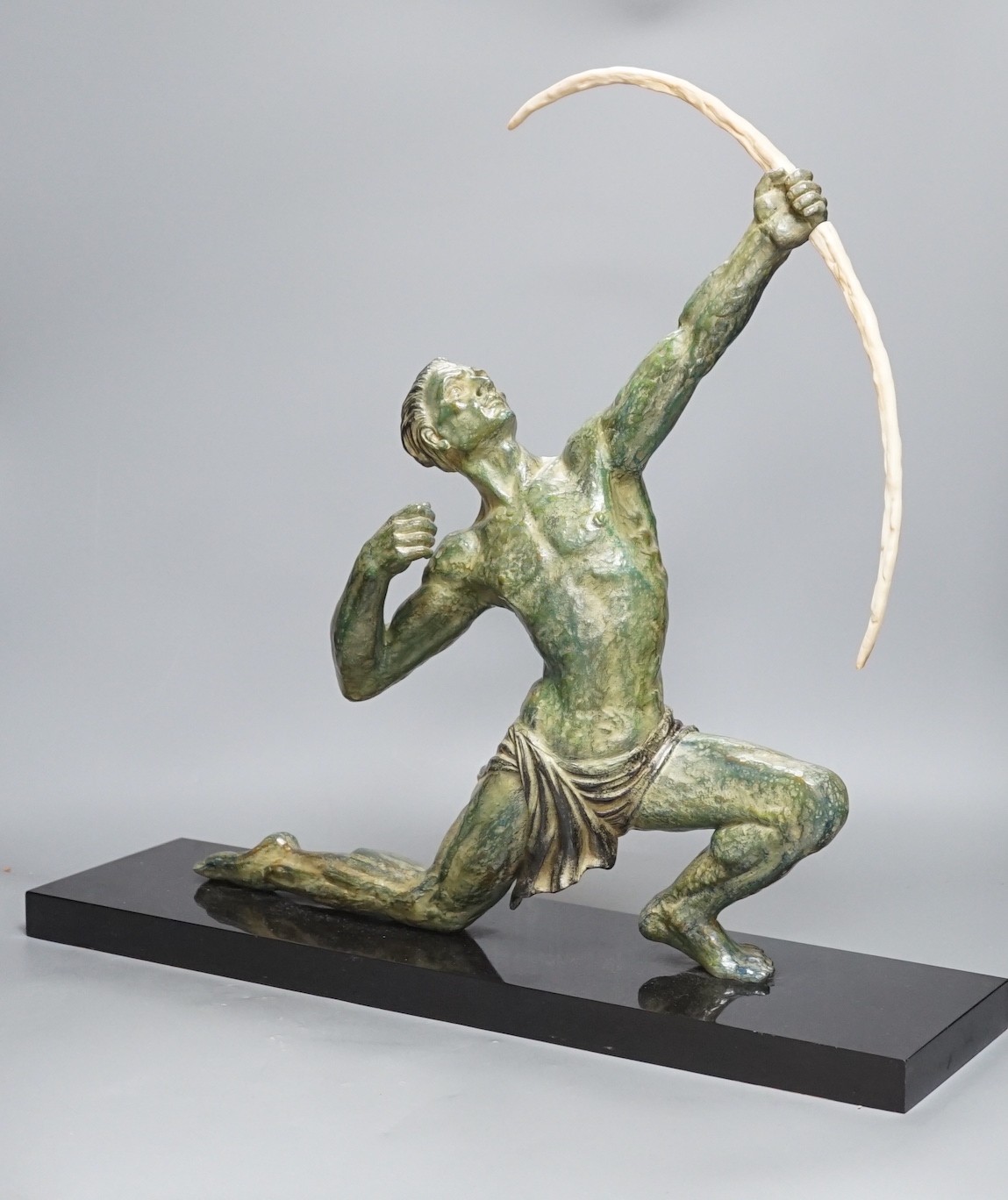 A large Art Deco bronzed figure of an archer, on black marble stand, 55 cms wide